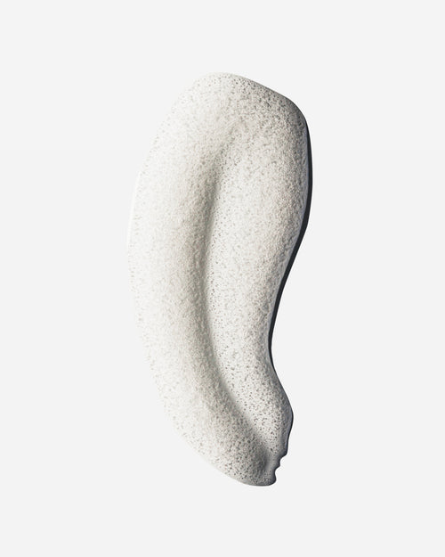 Foamy white shampoo swatch with airy bubble texture, showing the lather of Decibel thickening shampoo.
