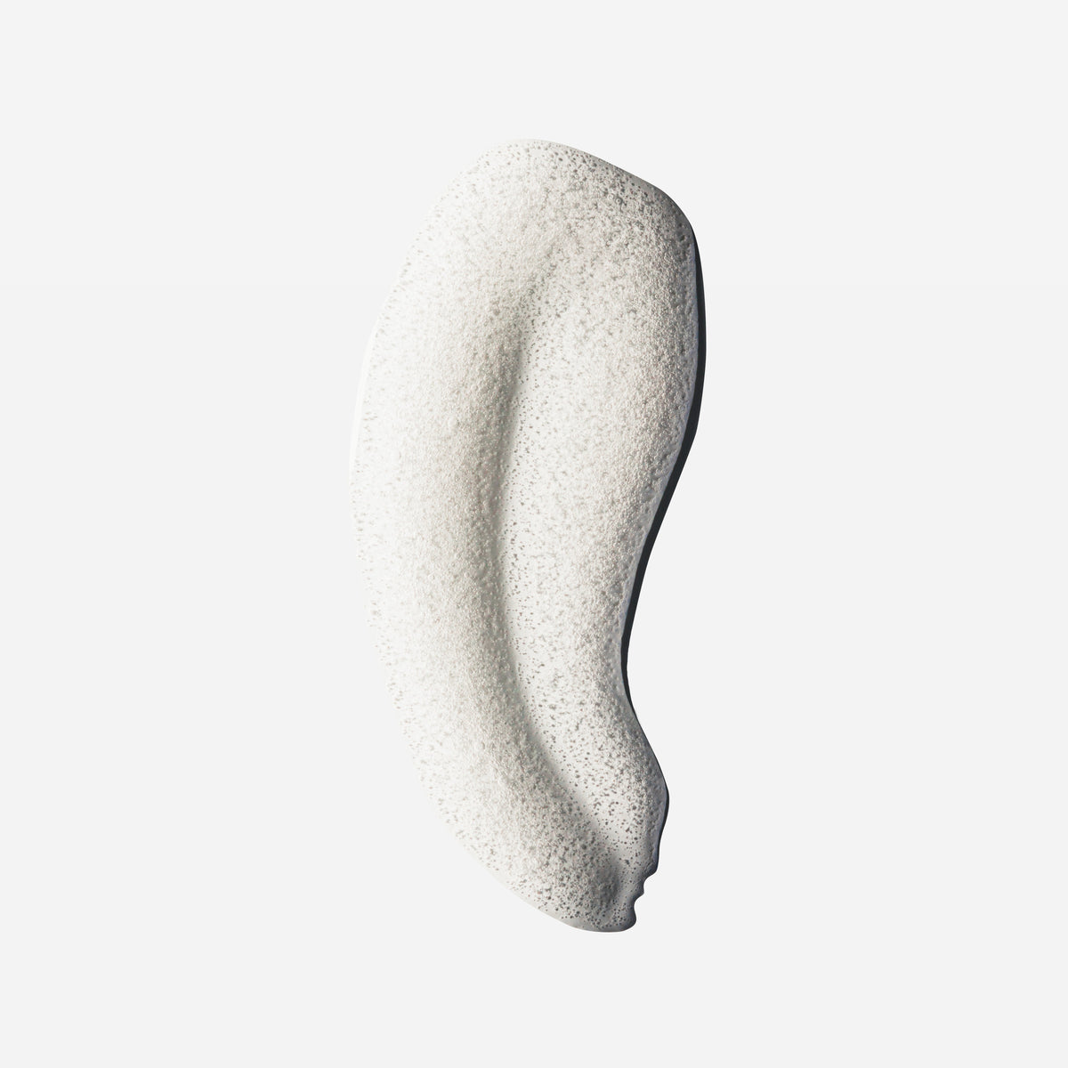Foamy white shampoo swatch with airy bubble texture, showing the lather of Decibel thickening shampoo.