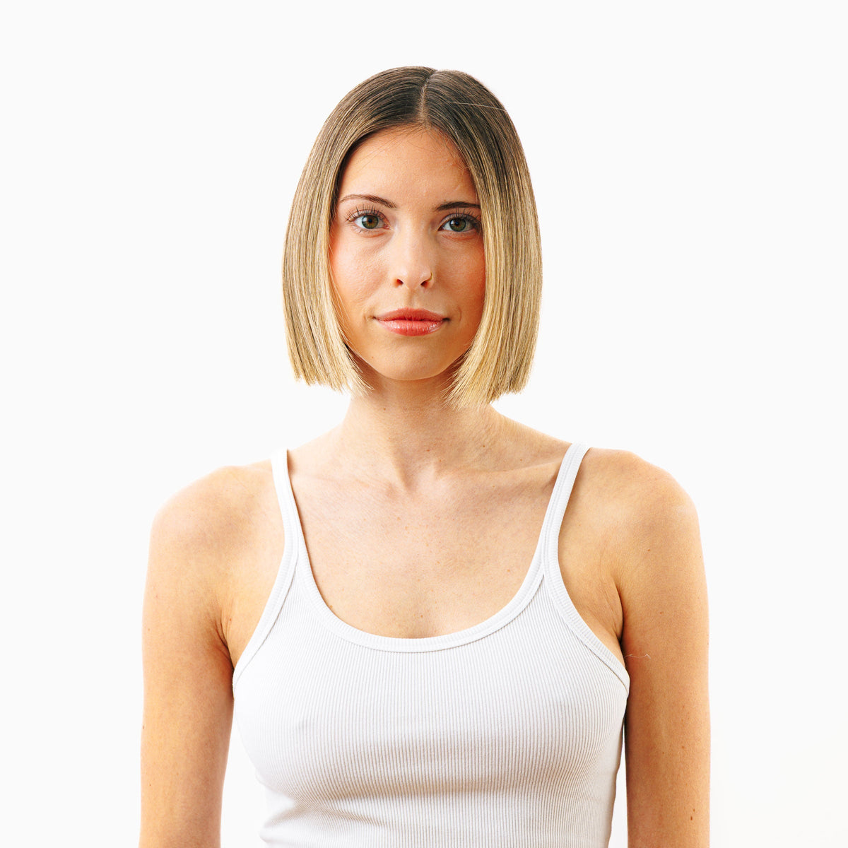 Before photo showing woman with flat, thin hair prior to using Decibel thickening hair care products.